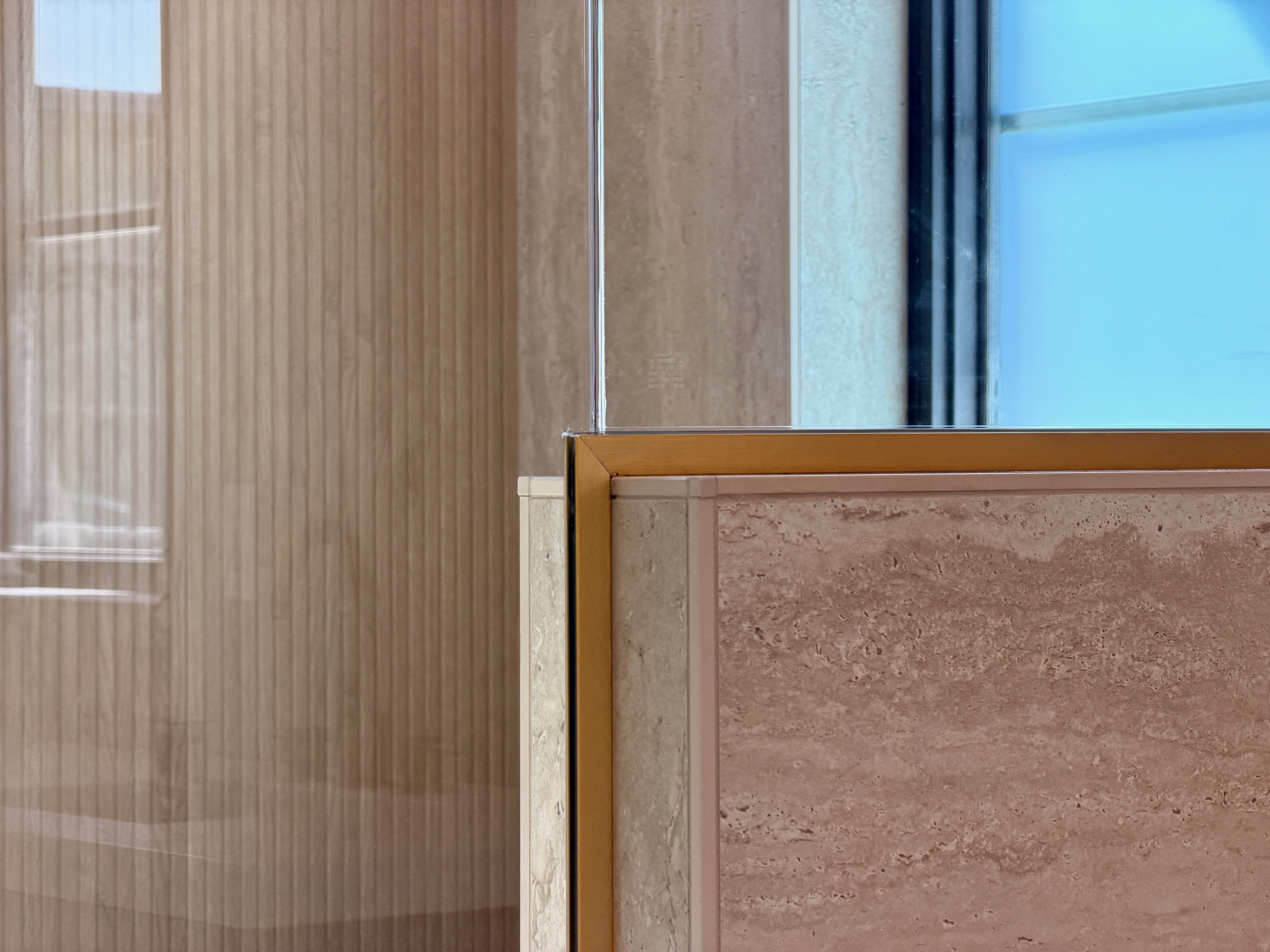 Gold-framed commercial glass installation detail